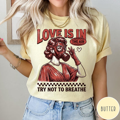 Comfort Colors tee in Butter featuring retro style graphic of a woman wearing a gas mask