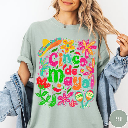 Comfort Colors tee in Bay featuring festive Cinco de Mayo graphic with flowers, sombrero, and maracas