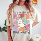 Comfort Colors tee in Ivory featuring cute duck graphic with colorful flowers and Sorry I Was Dilly Dallying text