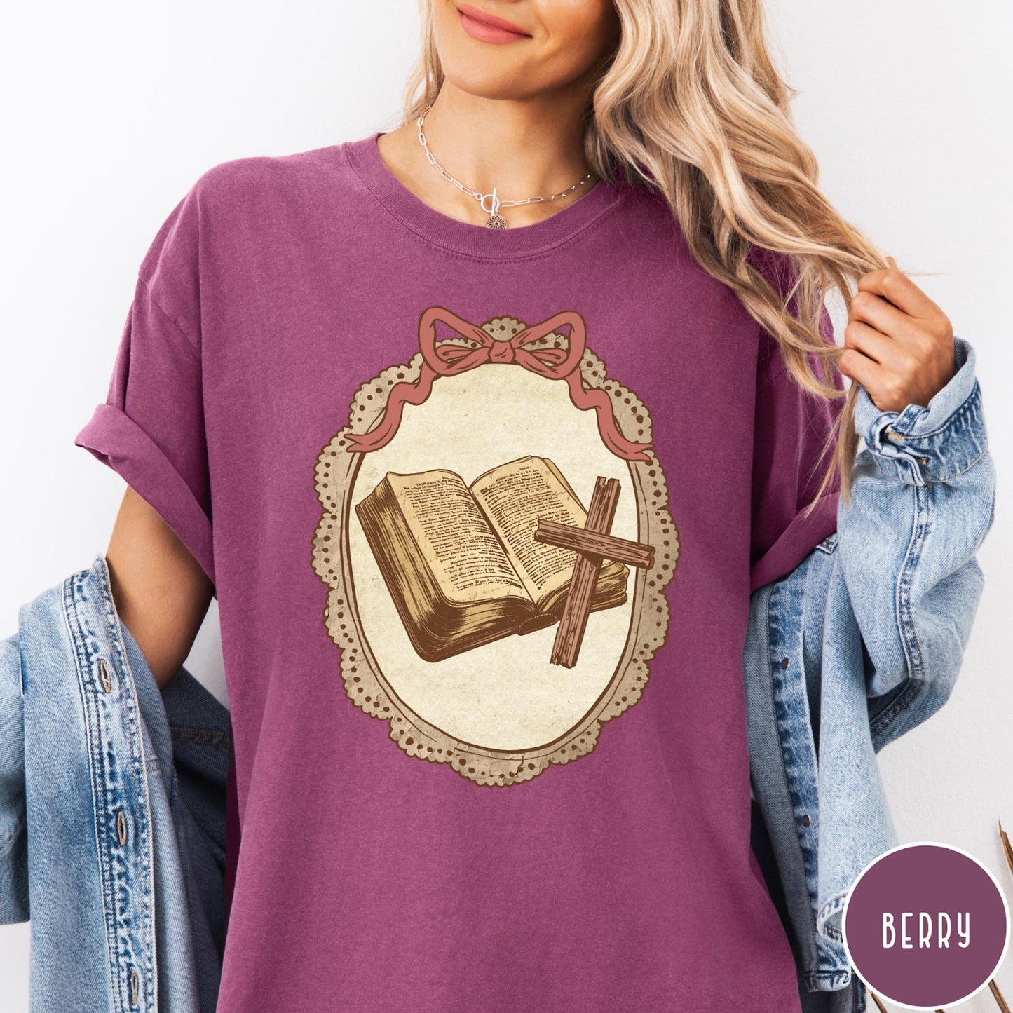 Comfort Colors tee in Berry featuring vintage style graphic of an open Bible and wooden Christian cross.