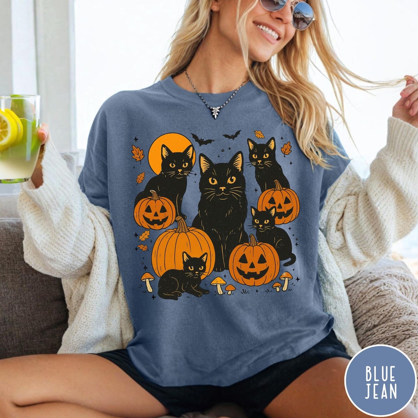 Comfort Colors tee in Blue Jean featuring Halloween style graphic with black cats, pumpkins, bats, and fall leaves