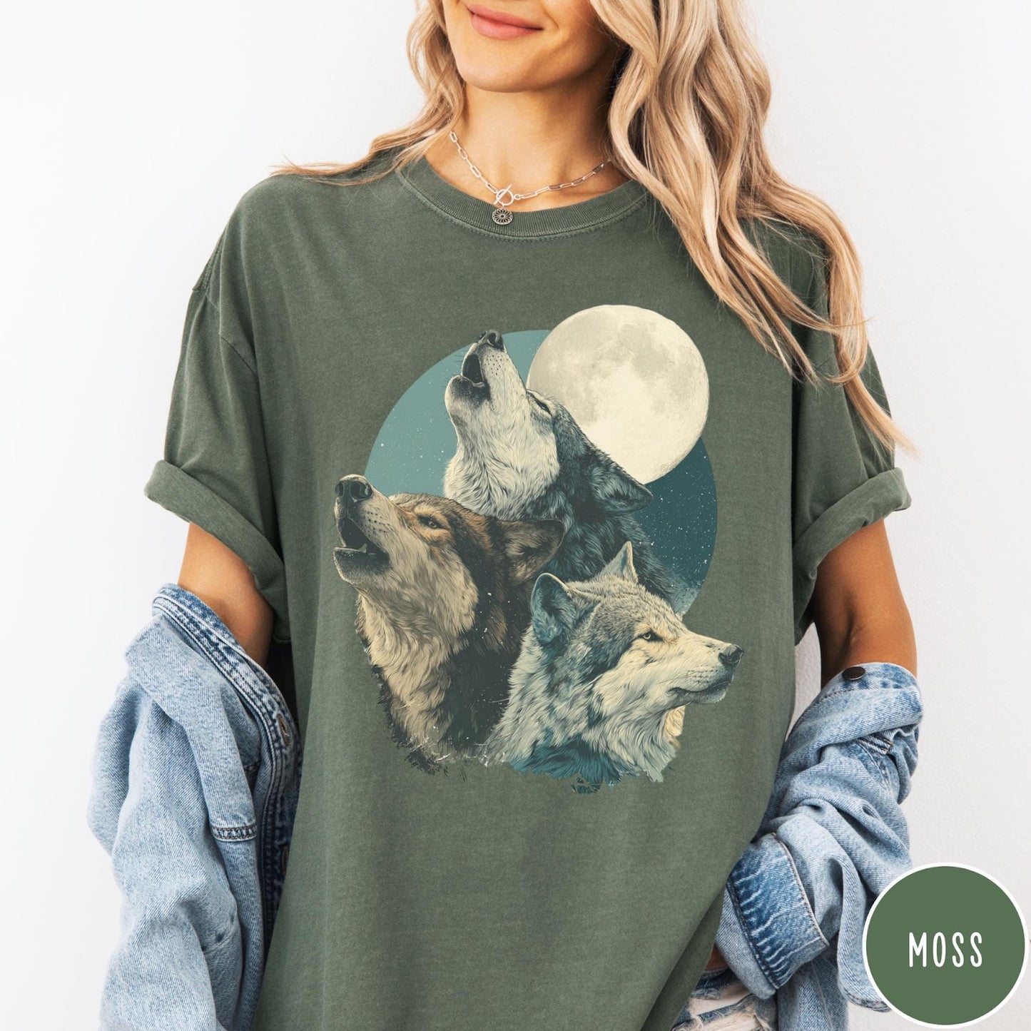 Comfort Colors tee in Moss featuring vintage style graphic of three howling wolves under a full moon
