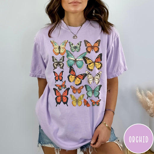 Comfort Colors tee in Orchid featuring butterfly collection design with various colorful butterfly illustrations in a grid