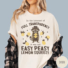 Comfort Colors tee in Ivory featuring graphic illustration of a raccoon wearing a hat holding a lemon