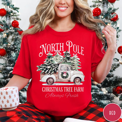 Comfort Colors tee in Red featuring vintage style Christmas tree farm truck graphic with snowy pine trees