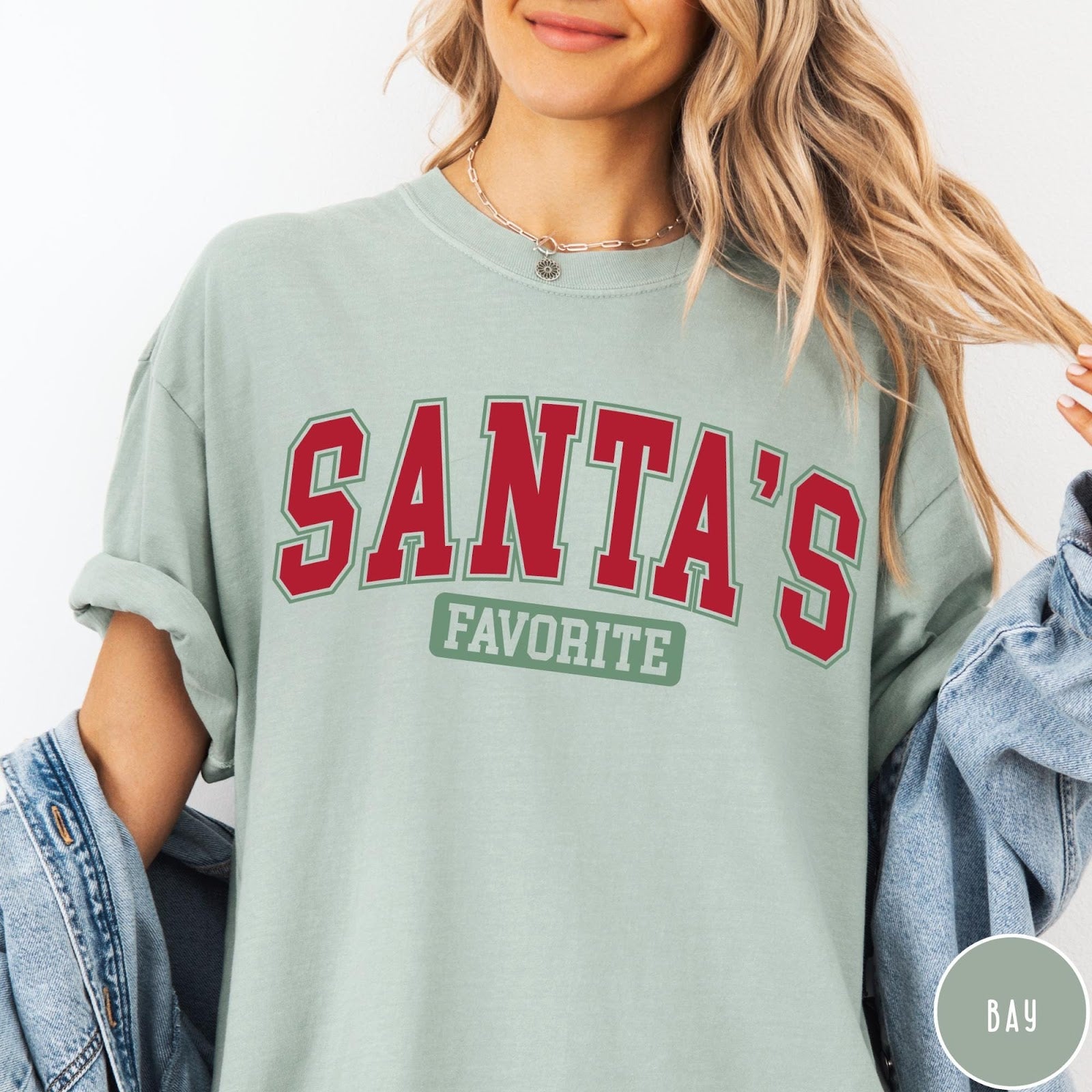 Comfort Colors tee in Bay featuring collegiate style Santa's Favorite Christmas graphic with red and green text