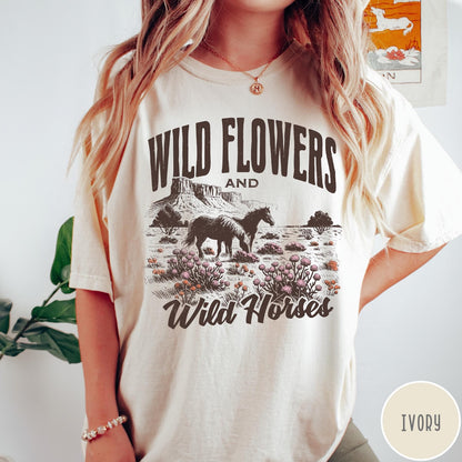 Comfort Colors tee in Ivory featuring western style graphic of wild horses grazing in a wildflower field