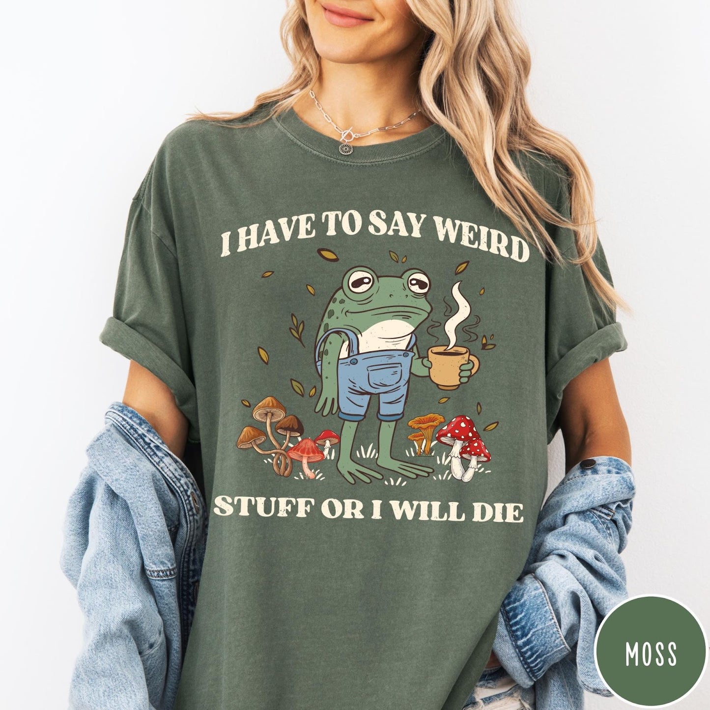 Comfort Colors tee in Moss featuring cartoon style frog wearing overalls holding a coffee mug with mushrooms