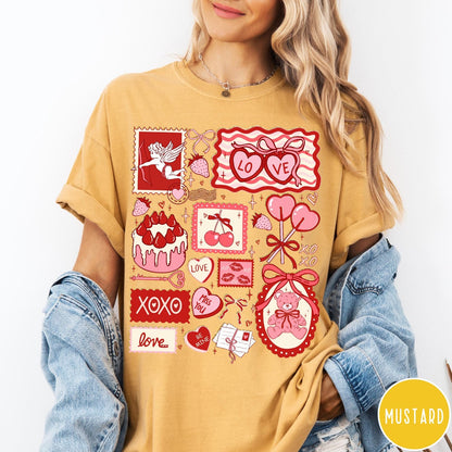 Comfort Colors tee in Mustard featuring Valentine collage graphic with cupid, teddy bear, hearts, and sweet treats
