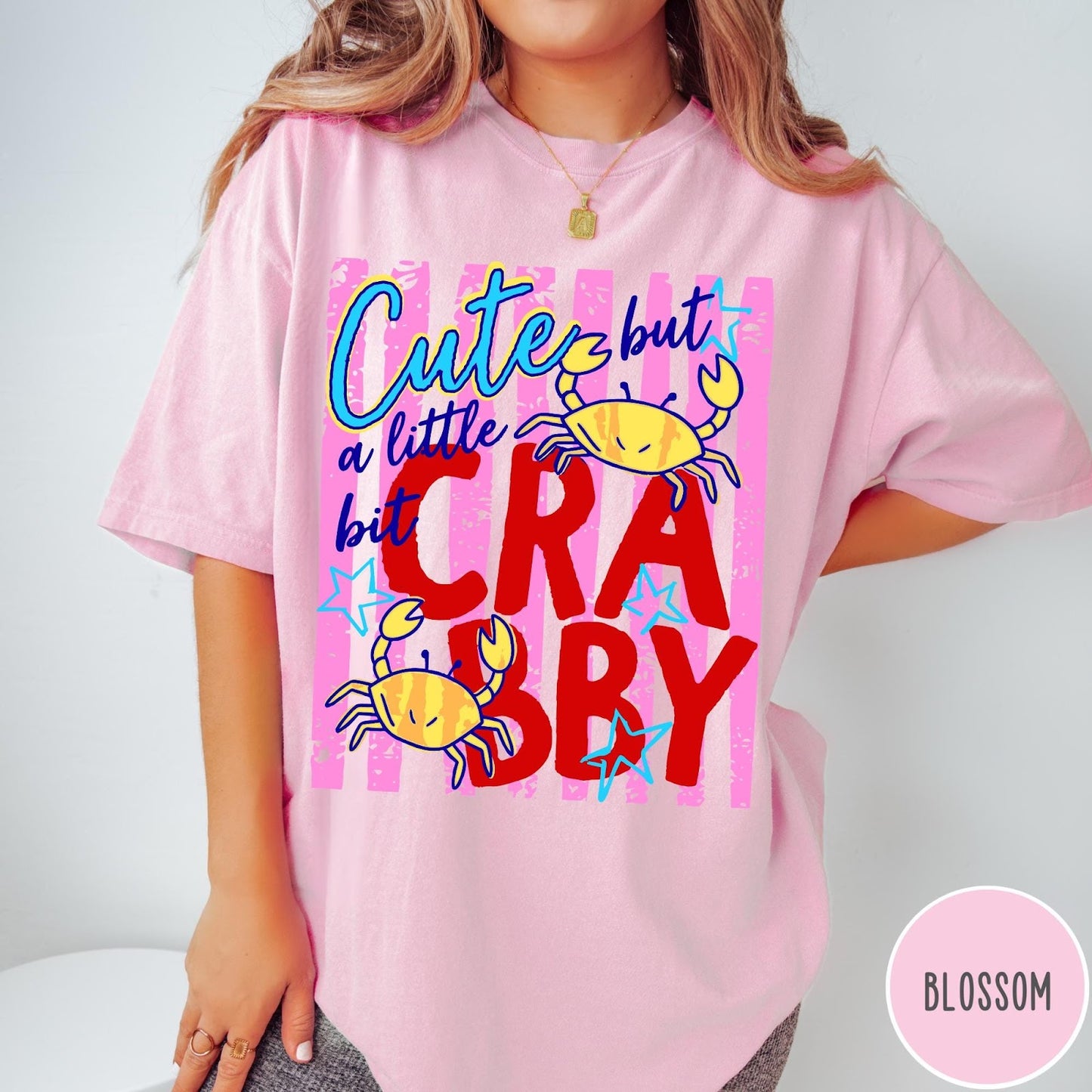 Comfort Colors tee in Blossom featuring playful graphic text and yellow crab illustrations with pink stripes