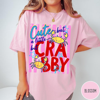 Comfort Colors tee in Blossom featuring playful graphic text and yellow crab illustrations with pink stripes