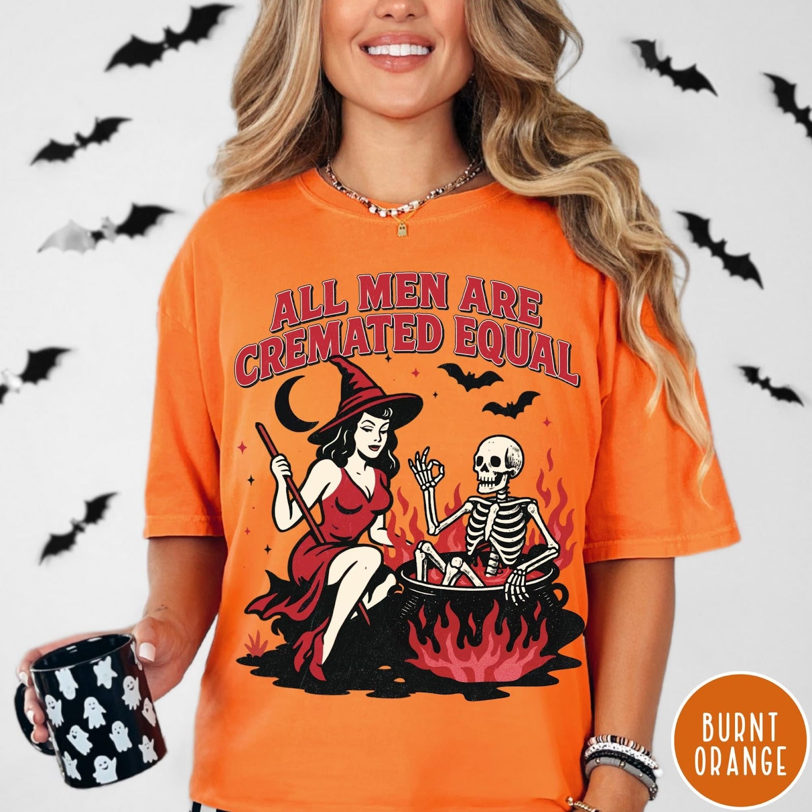 Comfort Colors tee in Burnt Orange featuring witch and skeleton graphic with a boiling cauldron and spooky text