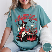 Comfort Colors tee in Seafoam featuring witch and skeleton graphic with a boiling cauldron and spooky text