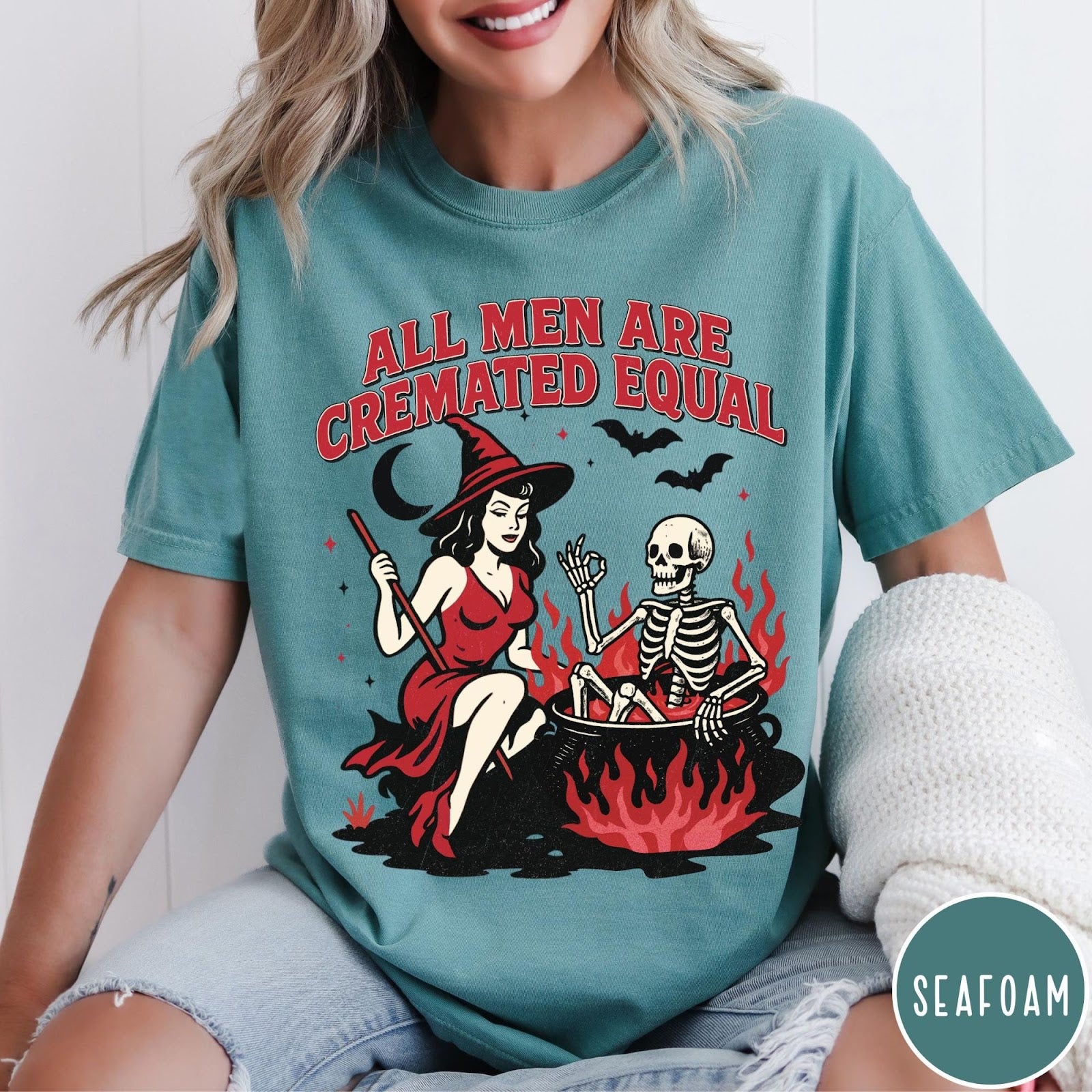 Comfort Colors tee in Seafoam featuring witch and skeleton graphic with a boiling cauldron and spooky text
