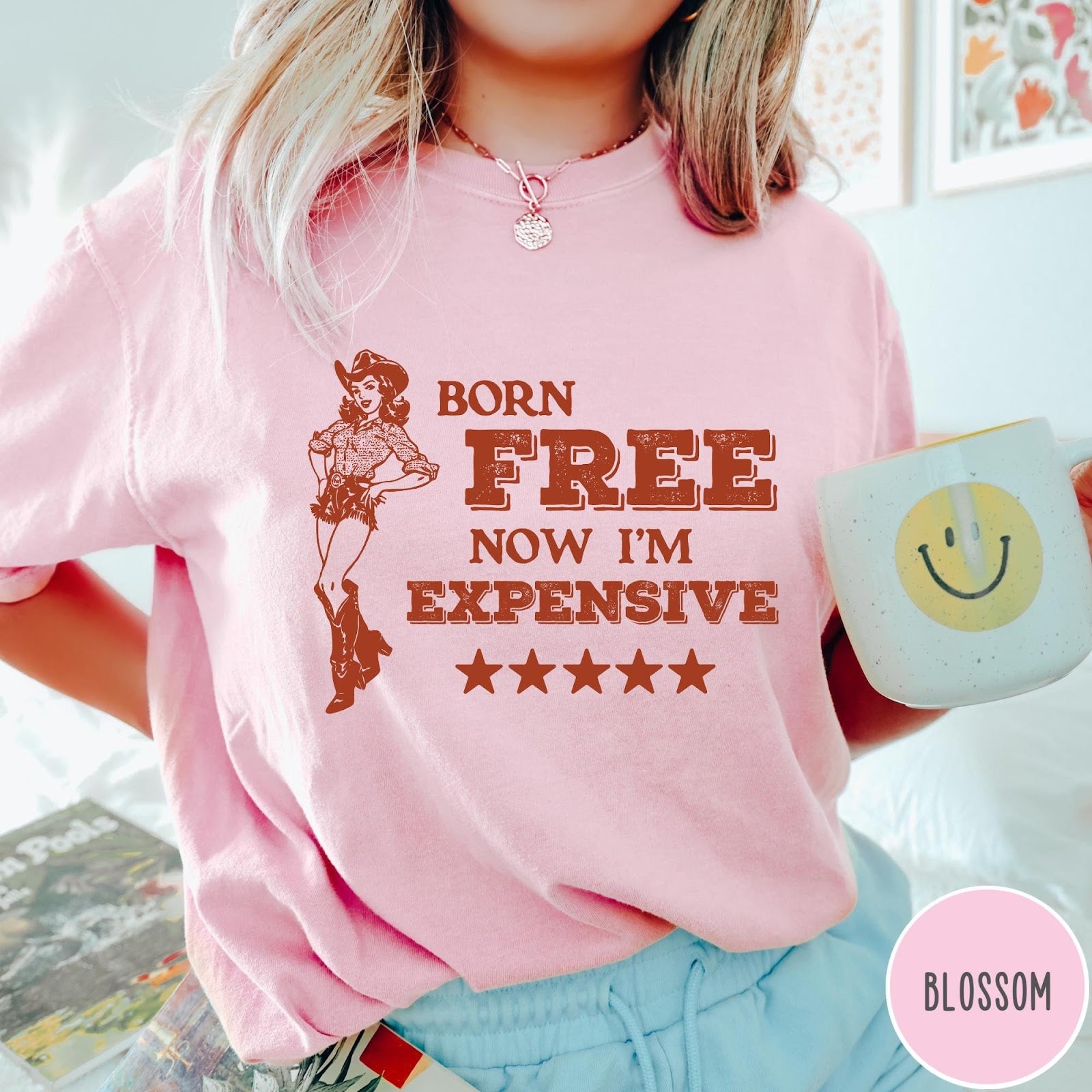 Comfort Colors tee in Blossom featuring cowgirl design with Born Free Now I'm Expensive text and stars