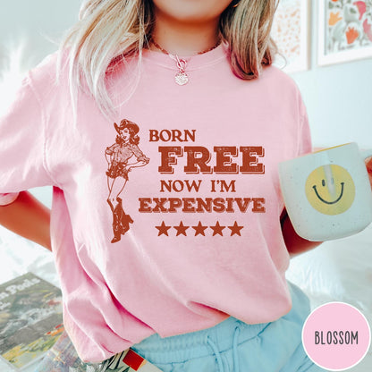 Comfort Colors tee in Blossom featuring cowgirl design with Born Free Now I'm Expensive text and stars