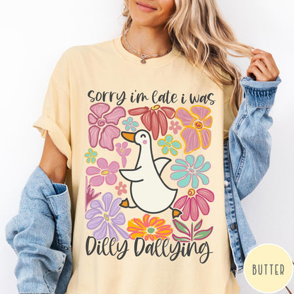 Comfort Colors tee in Butter featuring cute duck graphic with colorful flowers and Sorry I Was Dilly Dallying text