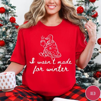 Comfort Colors tee in Red featuring line art graphic of a duck wrapped in a blanket drinking coffee