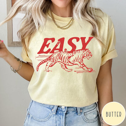 Comfort Colors tee in Butter featuring vintage style graphic of a walking tiger and text Easy