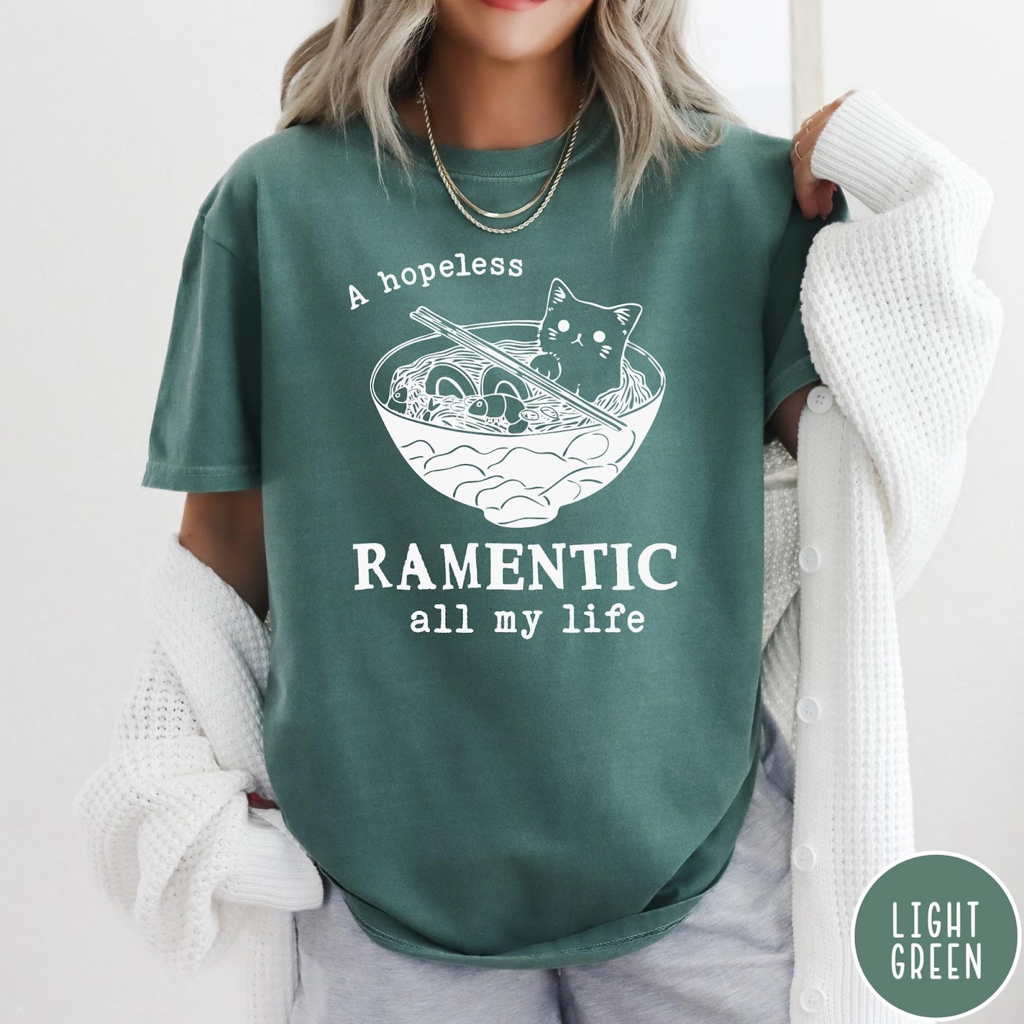 Comfort Colors tee in Light Green featuring line art graphic of a cute cat inside a ramen bowl