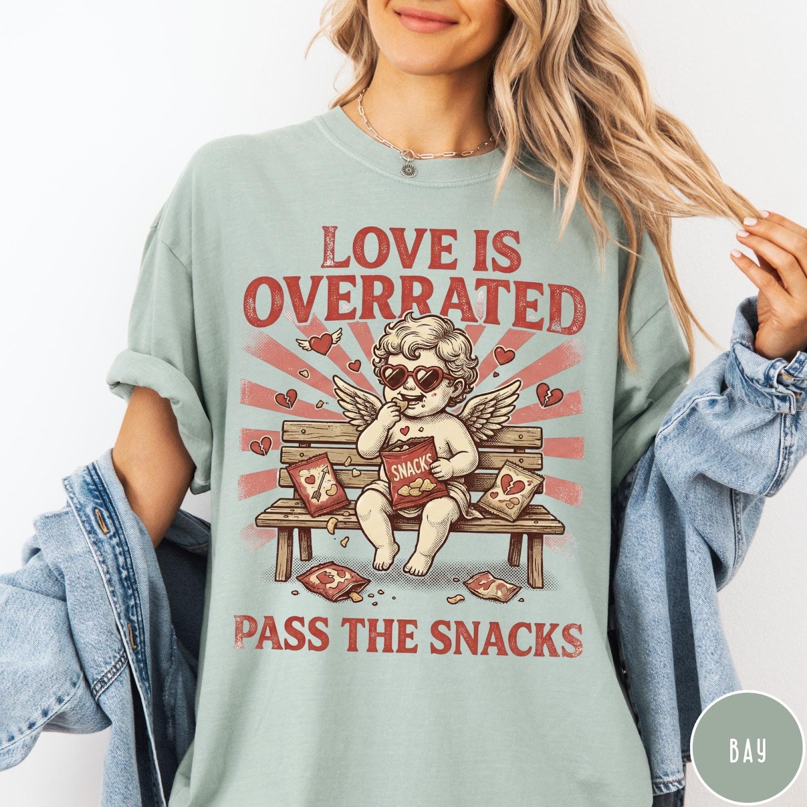 Comfort Colors tee in Bay featuring vintage style graphic of a cherub eating snacks on a bench