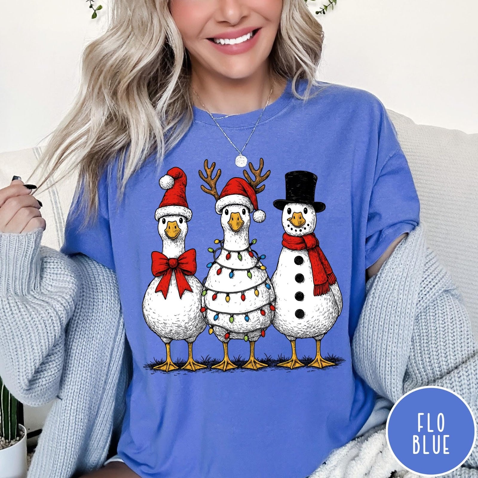 Comfort Colors tee in Flo Blue featuring festive holiday graphic of three geese dressed as Santa and snowman