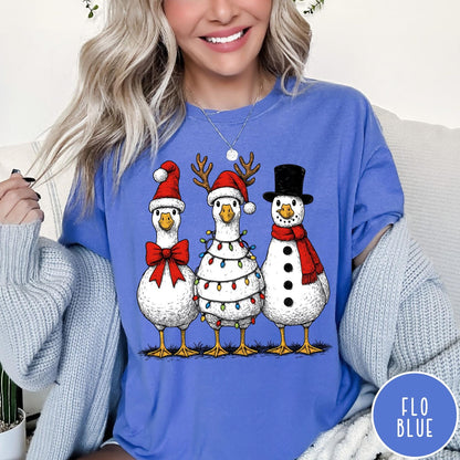 Comfort Colors tee in Flo Blue featuring festive holiday graphic of three geese dressed as Santa and snowman
