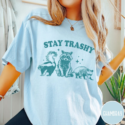 Comfort Colors tee in Chambray featuring graphic style raccoon, skunk, and opossum wearing sunglasses with Stay Trashy text