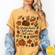Comfort Colors tee in Mustard featuring fall design style with turkey, pumpkin, pie, and autumn harvest elements