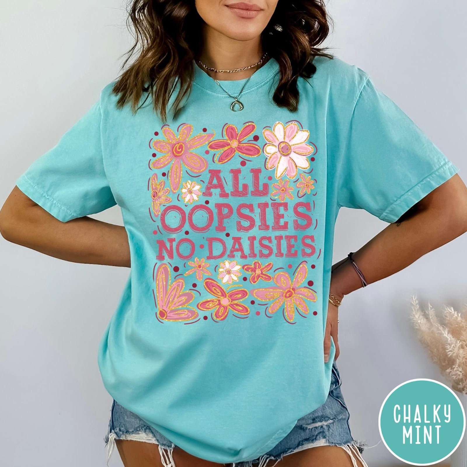 Comfort Colors tee in Chalky Mint featuring floral design with funny quote All Oopsies No Daisies text graphic
