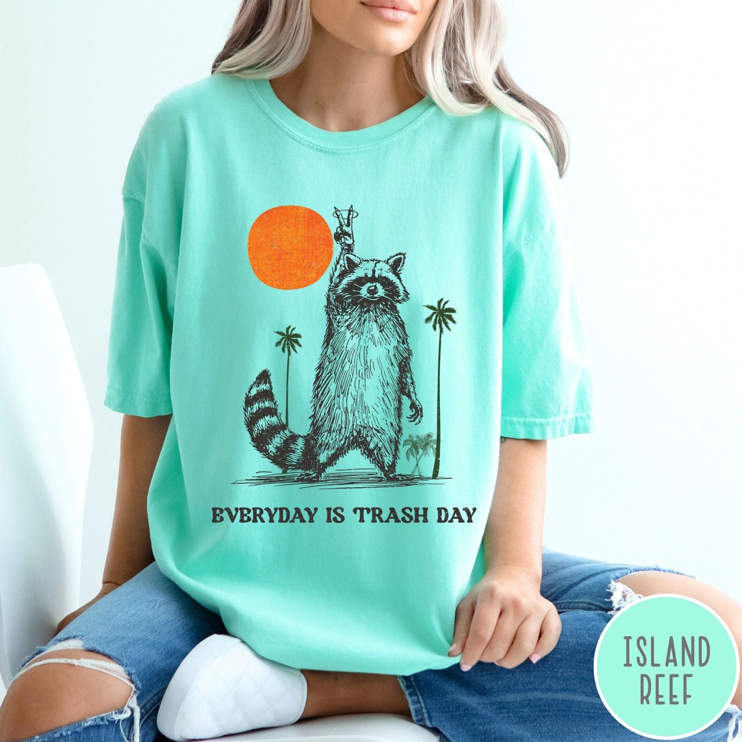 Comfort Colors tee in Island Reef featuring vintage style graphic of a raccoon making a peace sign