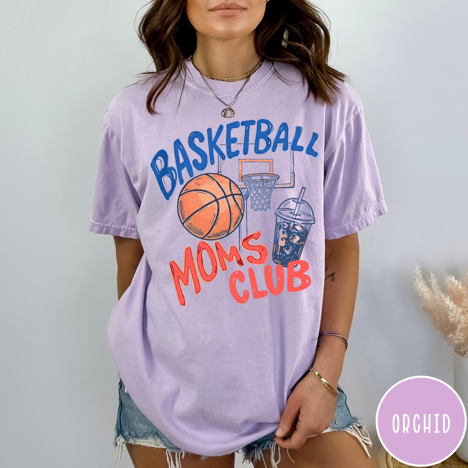 Comfort Colors tee in Orchid featuring basketball mom life graphic with basketball, hoop, and iced coffee