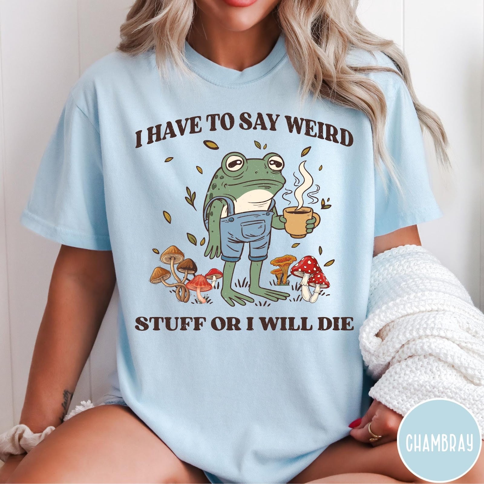 Comfort Colors tee in Chambray featuring illustrative frog graphic with coffee cup and various forest mushrooms
