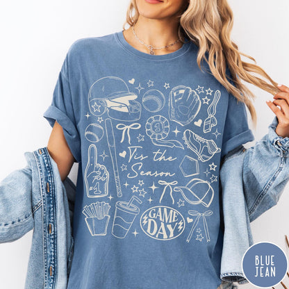 Comfort Colors tee in Blue Jean featuring baseball game day graphic with helmet, bat, ball, and snacks.