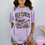 Comfort Colors tee in Orchid featuring western style graphic of wild horses grazing in a wildflower field