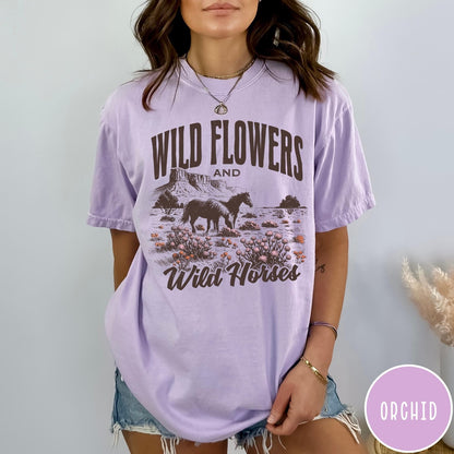 Comfort Colors tee in Orchid featuring western style graphic of wild horses grazing in a wildflower field