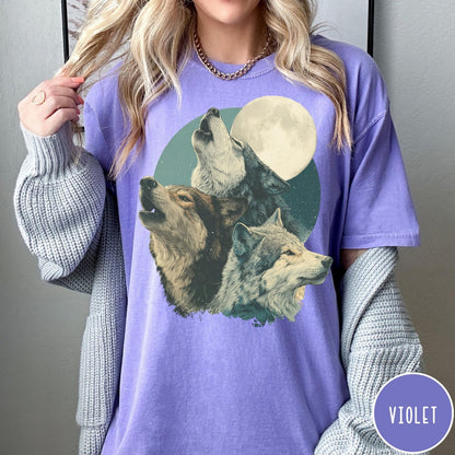 Comfort Colors tee in Violet featuring vintage style graphic of three wolves howling at a full moon