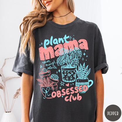 Comfort Colors tee in Pepper featuring graphic design with potted plants and Plant Mama Obsessed Club text
