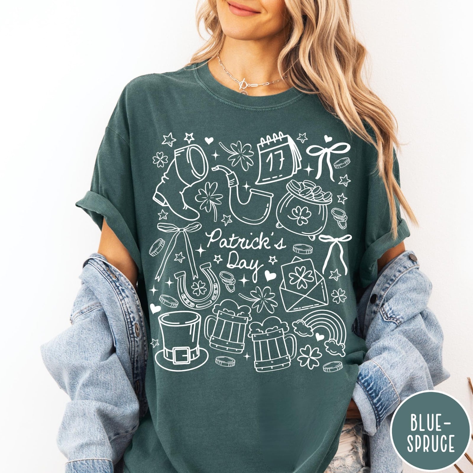 Comfort Colors tee in Blue Spruce featuring white line art style St. Patrick's Day icons including shamrocks and leprechaun hat