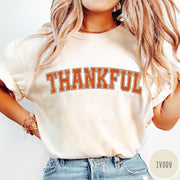 Comfort Colors tee in Ivory featuring typography graphic with the word Thankful in an arched varsity style