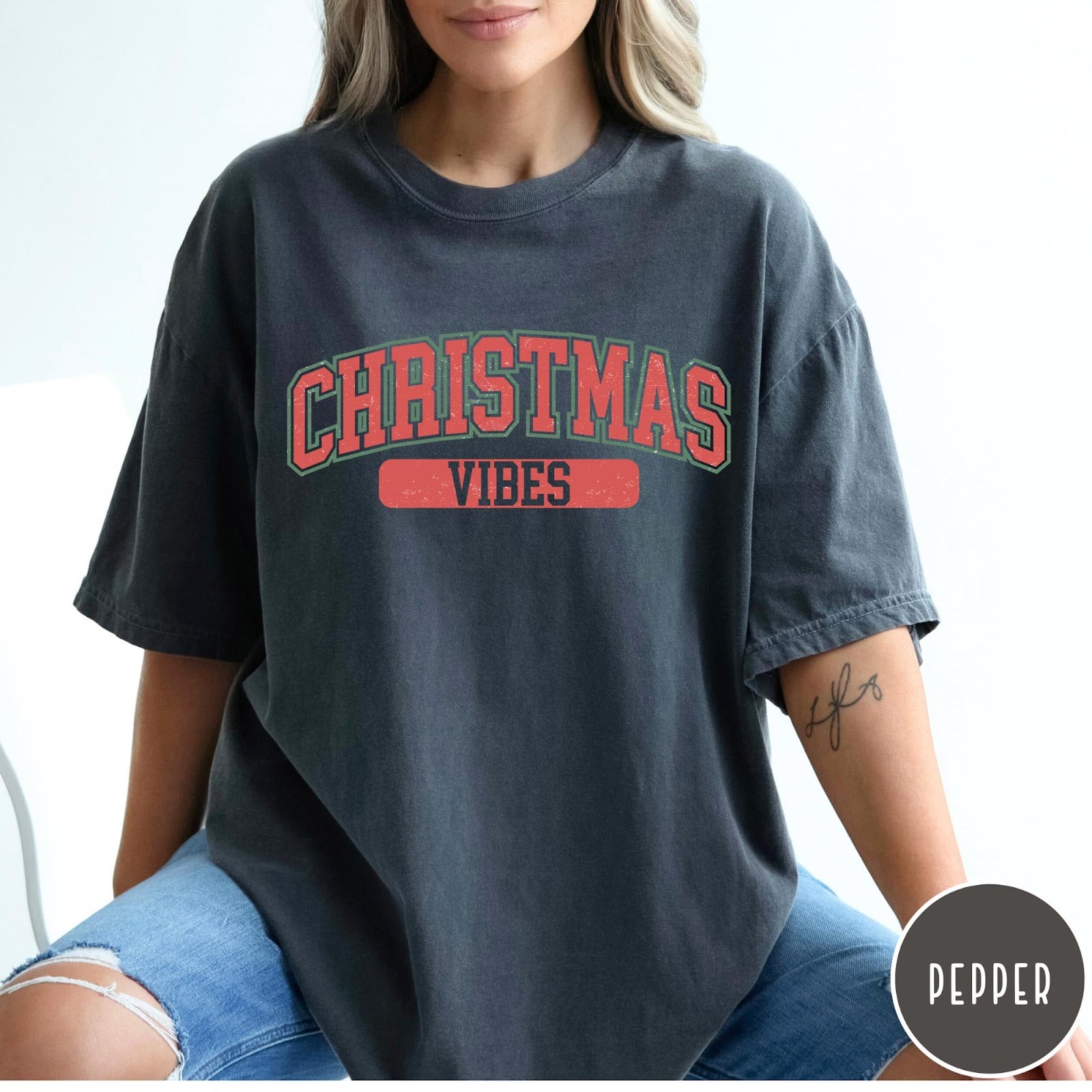 Comfort Colors tee in Pepper featuring Christmas holiday theme graphic with red and green text design