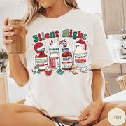 Comfort Colors tee in Ivory featuring holiday graphic with medical vials styled as festive holiday treats