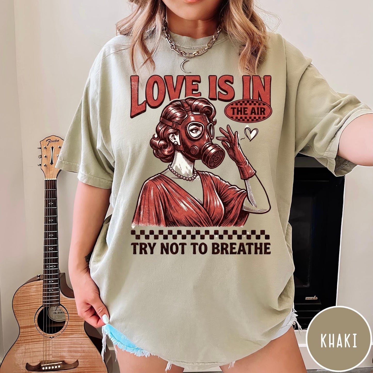 Comfort Colors tee in Khaki featuring retro graphic design of a woman wearing a gas mask