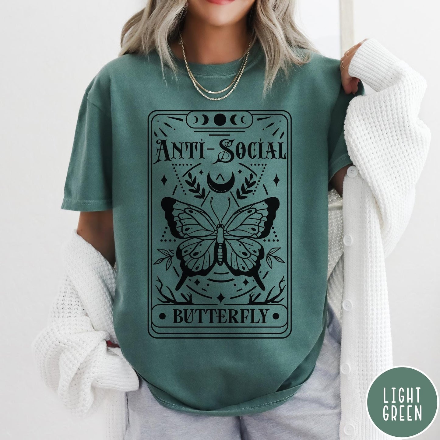 Comfort Colors tee in Light Green featuring tarot card style graphic with butterfly and celestial moon phase design