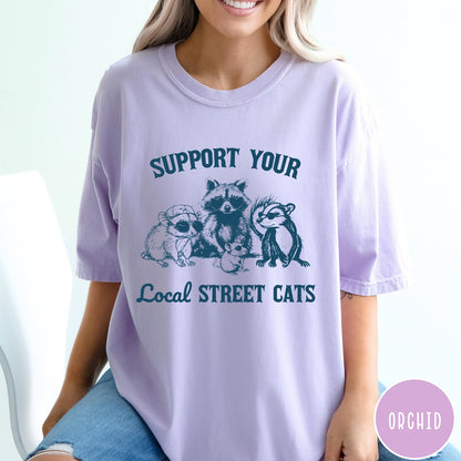 Comfort Colors tee in Orchid featuring illustration style graphic of a raccoon, opossum, and skunk wearing sunglasses