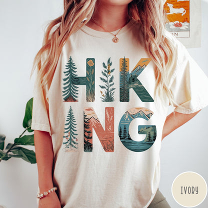Comfort Colors tee in Ivory featuring nature graphic with trees and mountains inside the word Hiking