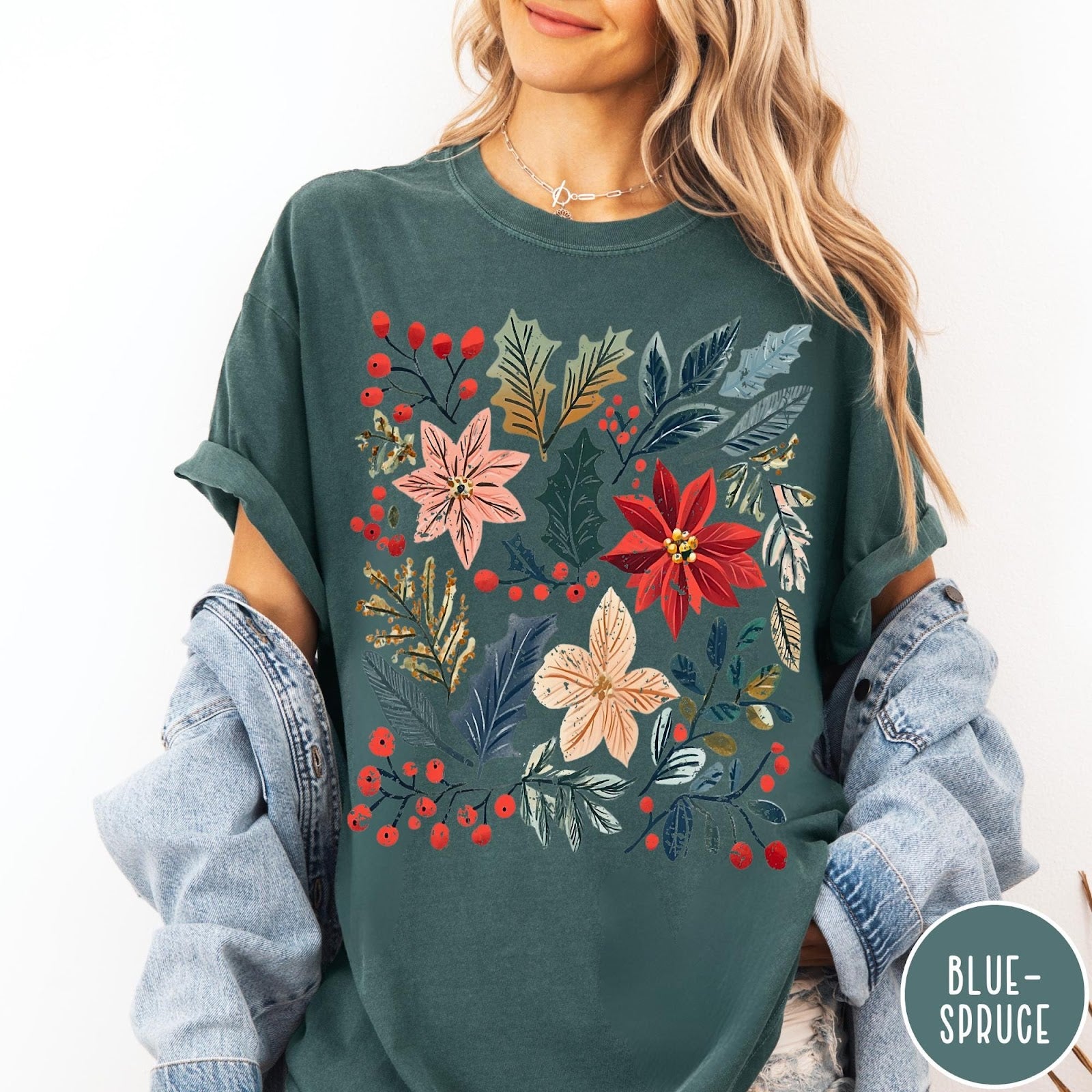 Comfort Colors tee in Blue Spruce featuring winter florals graphic with poinsettias, holly leaves, and red berries.