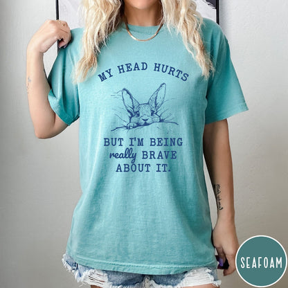 Comfort Colors tee in Seafoam featuring line art graphic of a bunny resting its head on a pillow