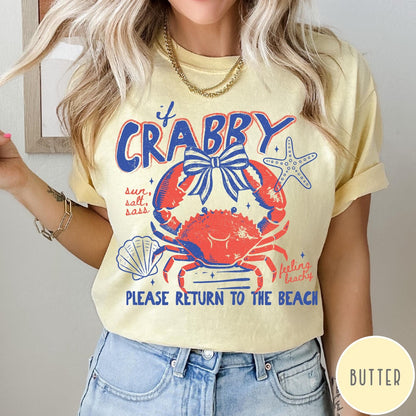 Comfort Colors tee in Butter featuring beachy crab graphic with bow, starfish, seashell, and coastal text