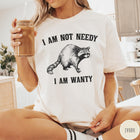 Comfort Colors tee in Ivory featuring vintage style graphic of a raccoon with text I Am Not Needy